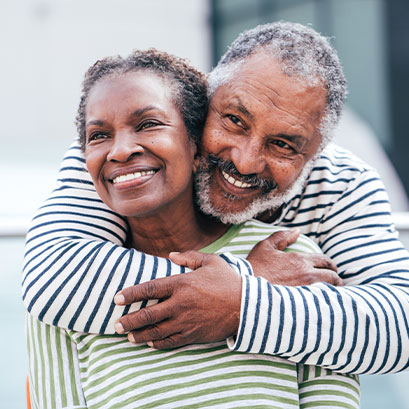 Photo of a man and woman smiling. Links to Beneficiary Designations