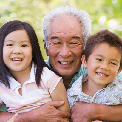 Photo of a grandfather with his grandchildren. Links to Closely Held Business Stock