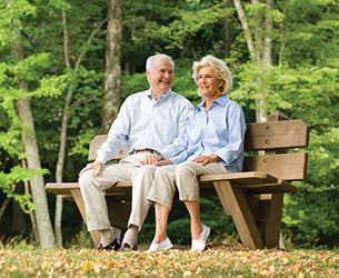 Photo of a couple sitting on a bench. Links to Gifts by Will